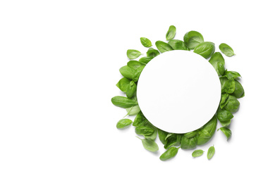 Photo of Green basil leaves and blank card on white background, top view. Space for text