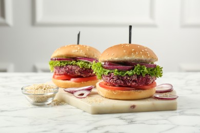 Photo of Tasty vegetarian burgers with beet patties on white marble table