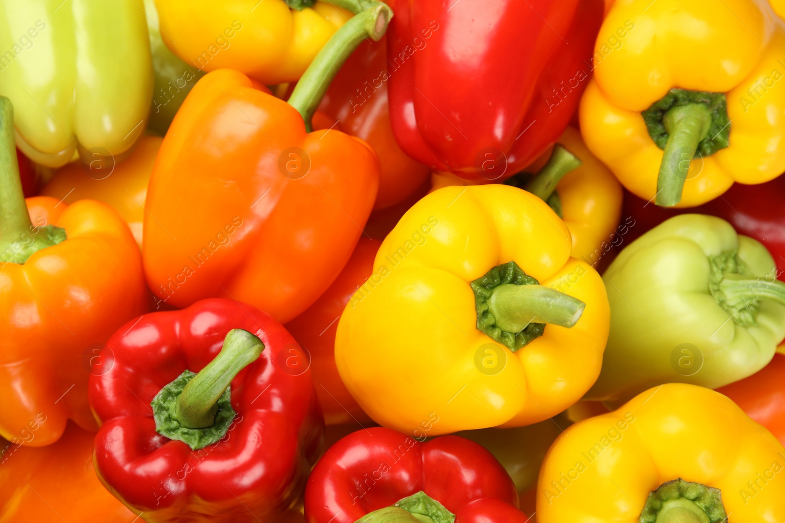 Photo of Fresh ripe colorful bell peppers as background, top view