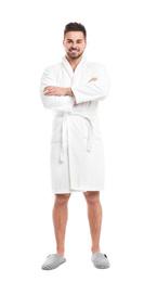 Handsome man wearing bathrobe on white background