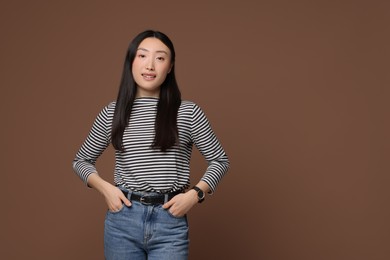 Photo of Portrait of smiling woman on brown background. Space for text