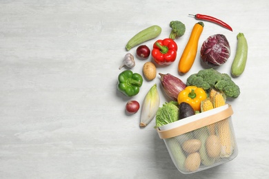 Photo of Flat lay composition with different vegetables and basket on light background. Space for text