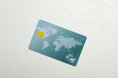 Credit card on white table, top view