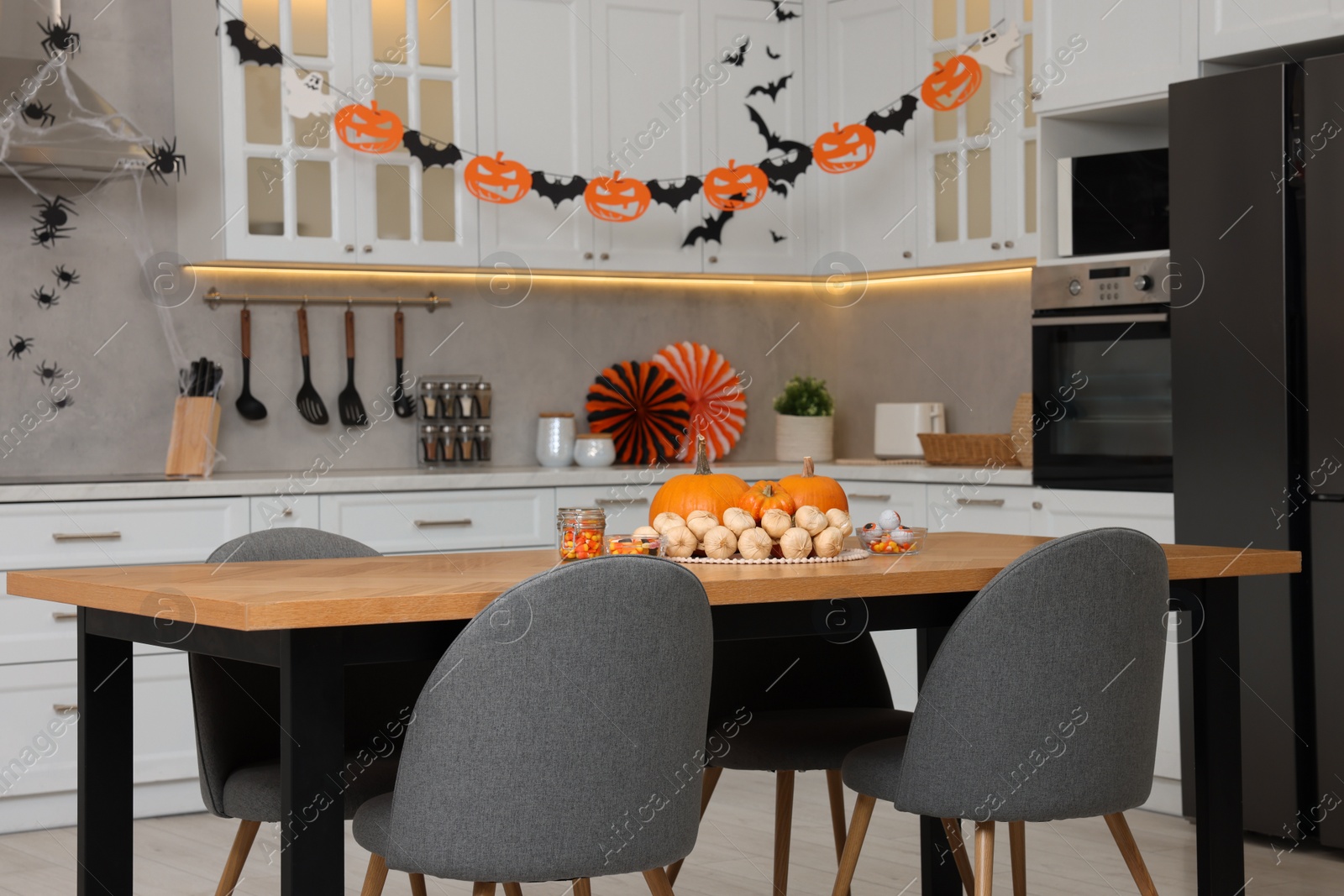 Photo of Stylish kitchen interior with festive decor. Halloween celebration