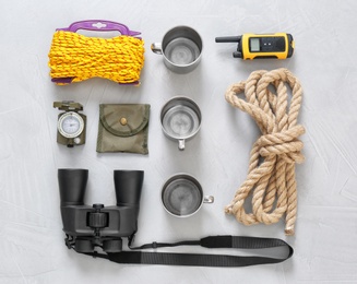 Photo of Flat lay composition with camping equipment on grey background