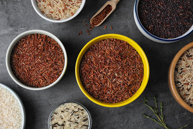 Photo of Flat lay composition with brown rice on grey table