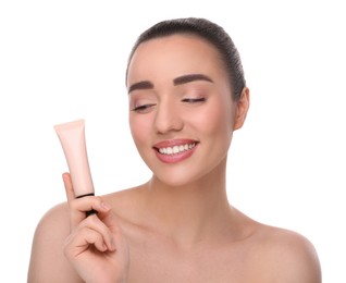 Photo of Woman holding tube of foundation on white background