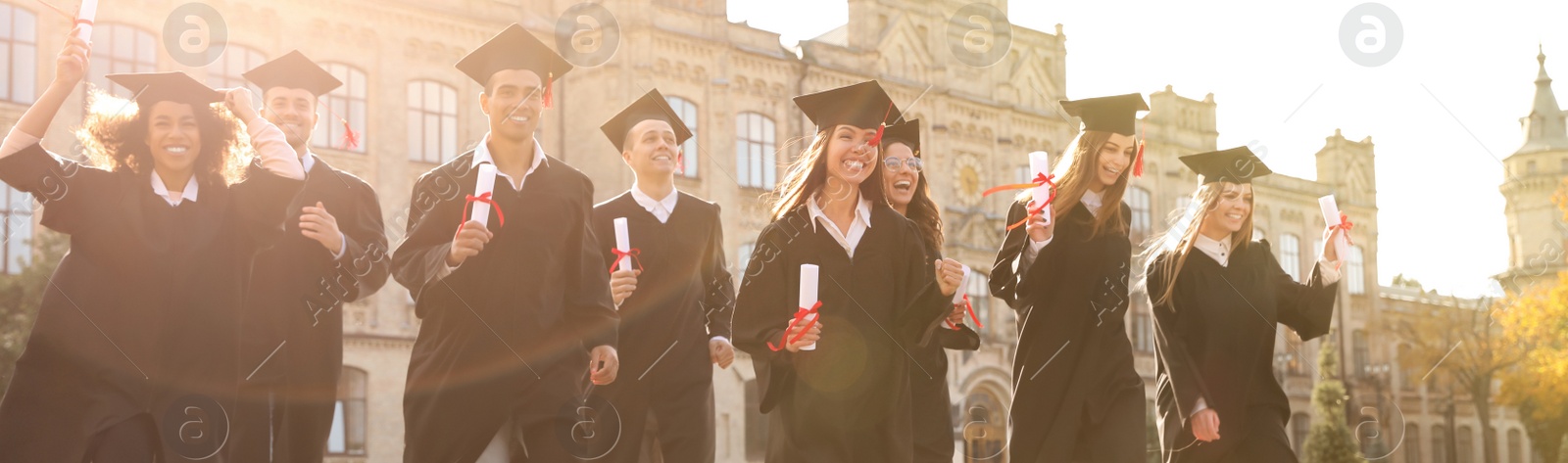 Image of Happy students with diplomas near campus. Banner design