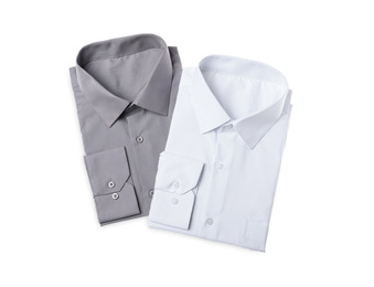 Stylish shirts isolated on white, top view. Dry-cleaning service