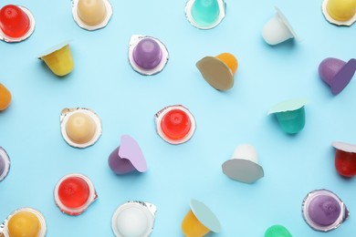Photo of Tasty bright jelly cups on light blue background, flat lay