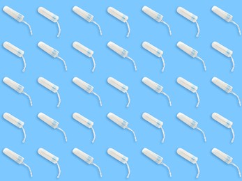 Image of Many tampons on light blue background, flat lay 