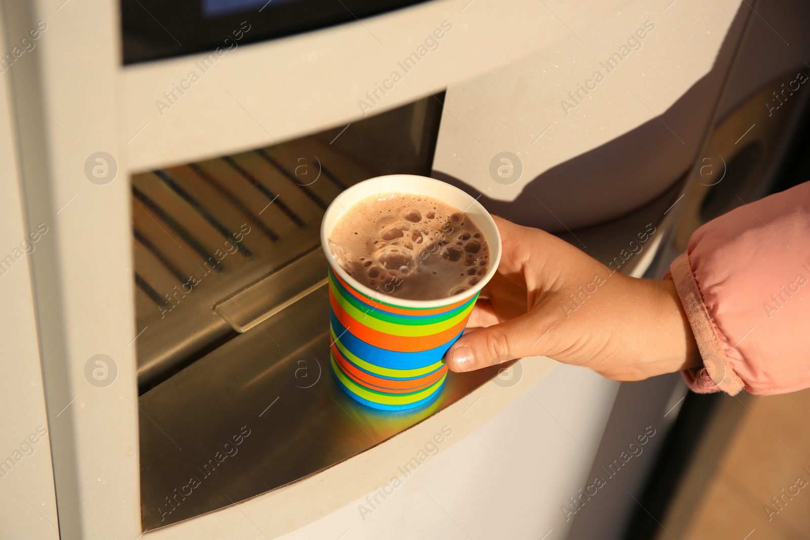 Photo of Woman taking paper cup with coffee from vending machine, closeup