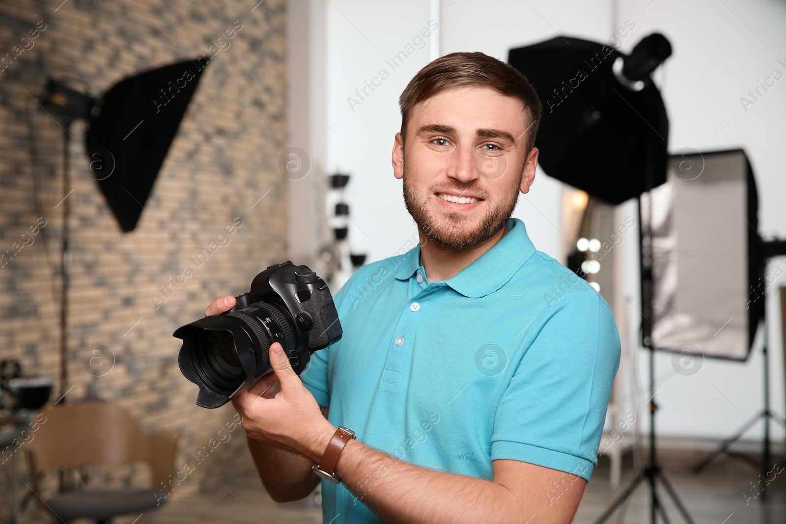 Photo of Professional photographer with camera in photo studio