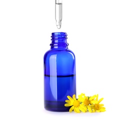 Dropping herbal essential oil into bottle isolated on white