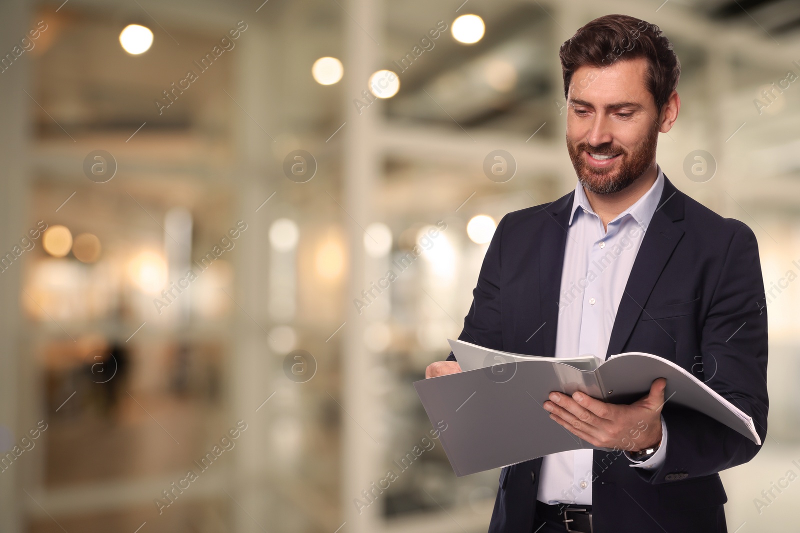 Image of Successful lawyer reading documents on blurred background, space for text