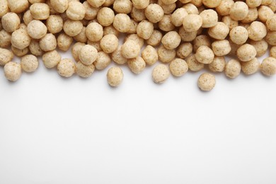 Photo of Tasty cereal balls on white background, flat lay