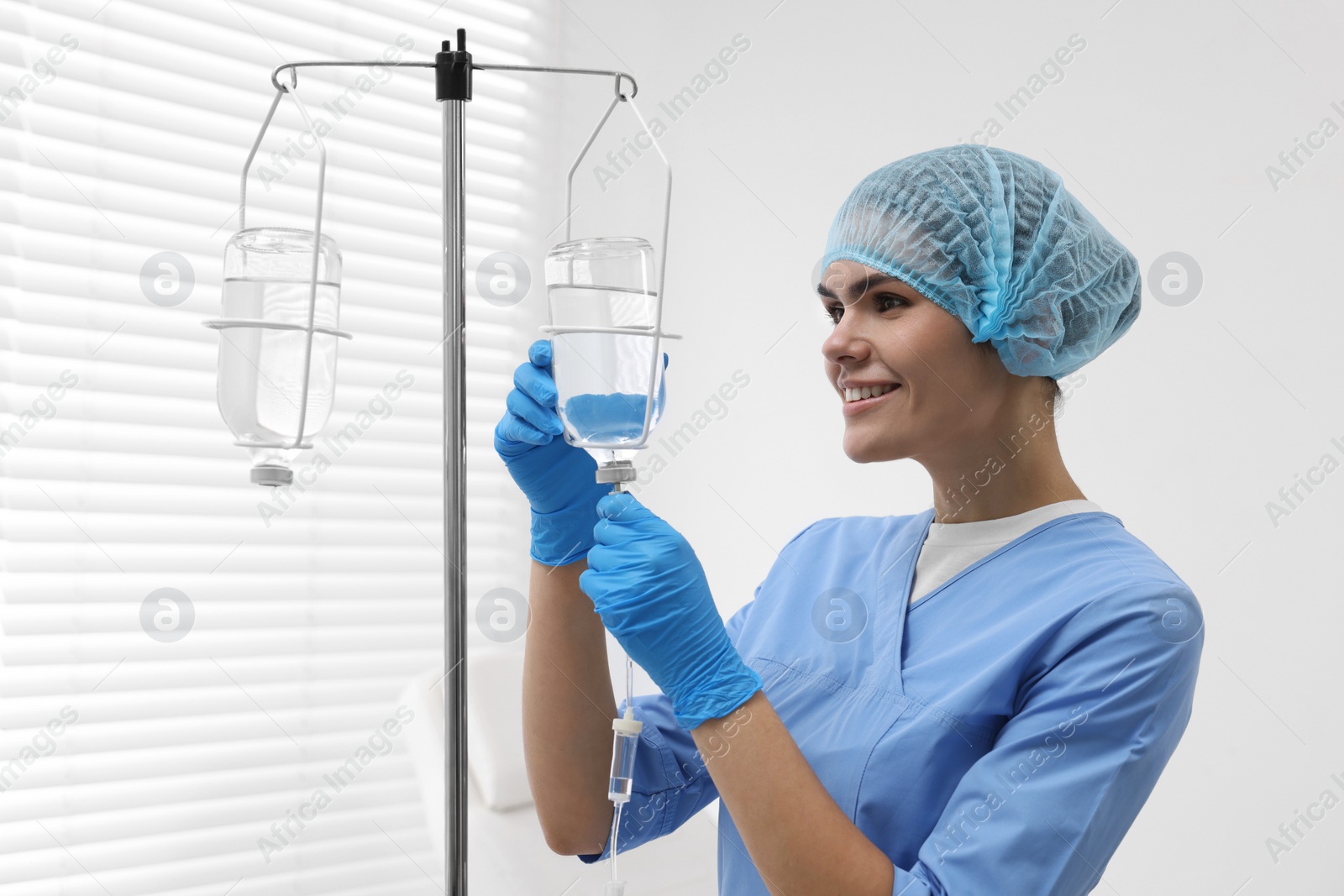 Photo of Nurse setting up IV drip in hospital