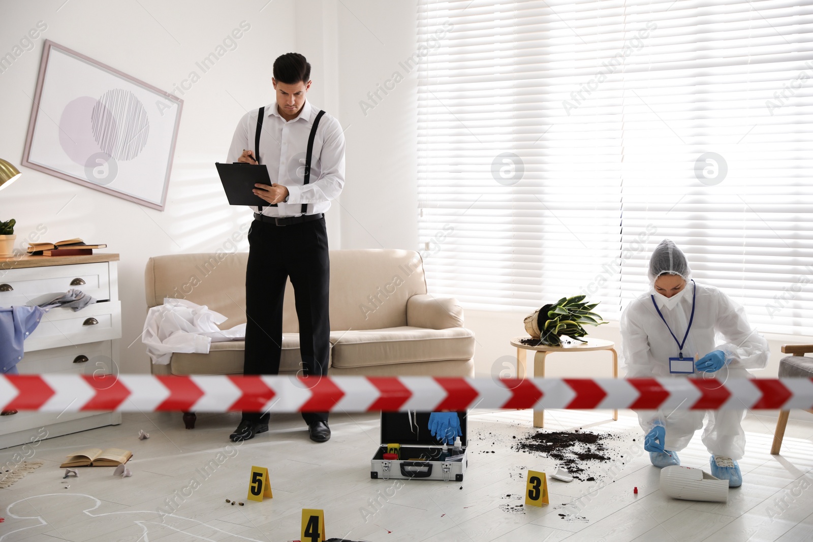 Photo of Investigators working at crime scene in living room