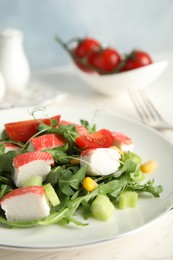 Photo of Tasty crab stick salad served on white table, closeup. Space for text
