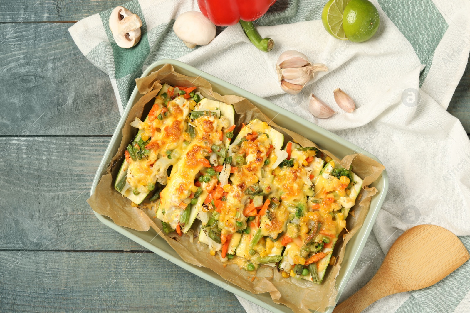 Photo of Flat lay composition with stuffed zucchinis on rustic table