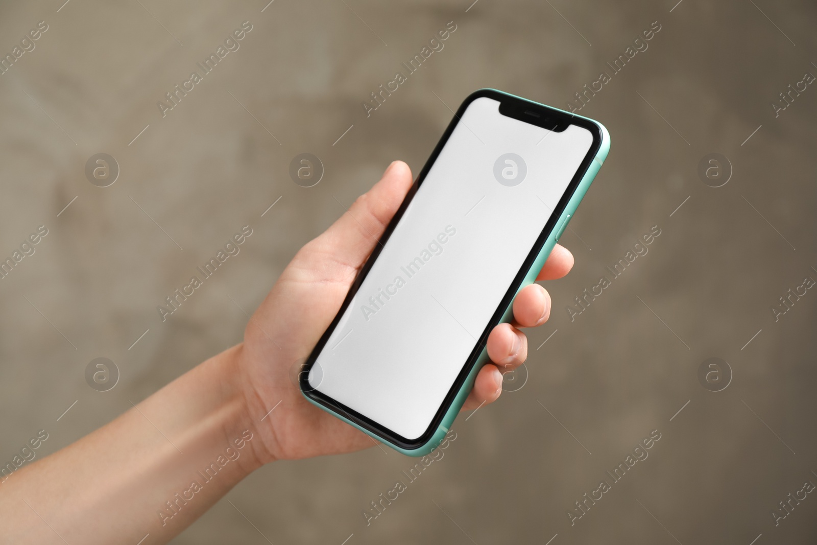Photo of MYKOLAIV, UKRAINE - JULY 8, 2020: Woman holding Iphone 11 Pro Max with blank screen on color background, closeup