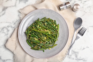 Photo of Yummy green beans with almonds served on table, top view