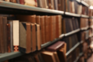 Blurred view of books on shelves in library