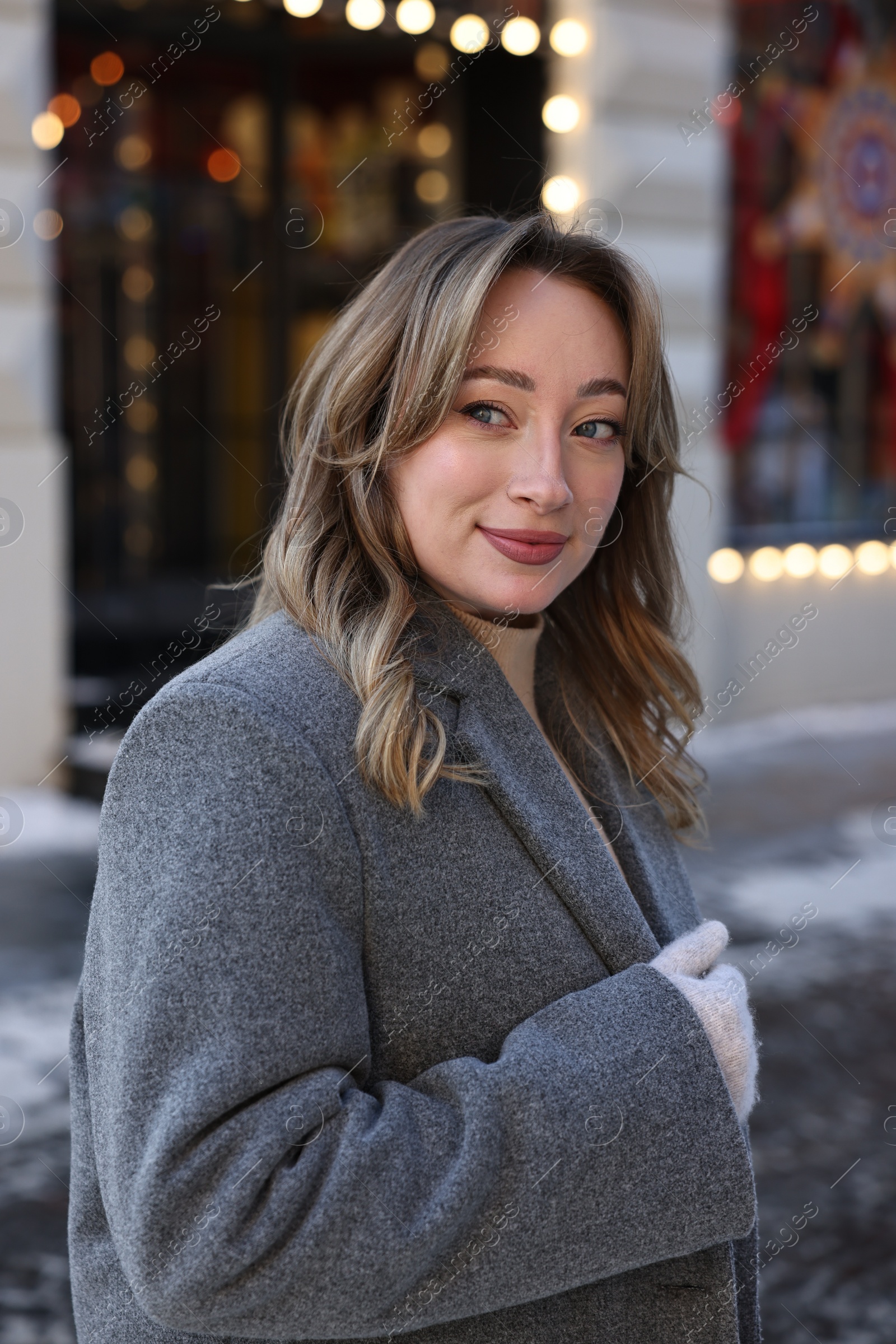 Photo of Portrait of charming woman on city street in winter