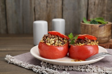 Photo of Delicious stuffed tomatoes with minced beef, bulgur and mushrooms served on table, closeup
