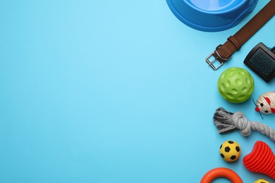 Photo of Different pet toys and accessories on light blue background, flat lay. Space for text