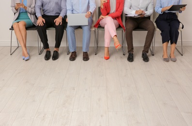 Group of young people waiting for job interview on chairs