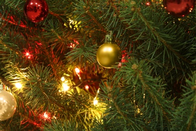 Photo of Glowing bright fairy lights and beautiful baubles on Christmas tree