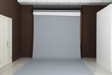 Photo of Empty grey photo background. Professional studio equipment