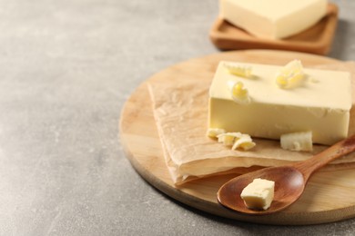 Photo of Block of tasty butter on grey table. Space for text