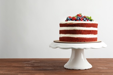 Photo of Delicious homemade red velvet cake and space for text on light background