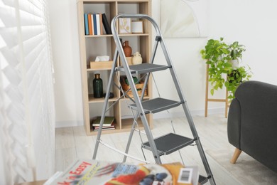 Metal folding ladder in stylish living room