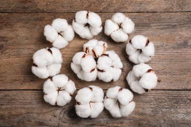 Flat lay composition with cotton flowers on wooden background