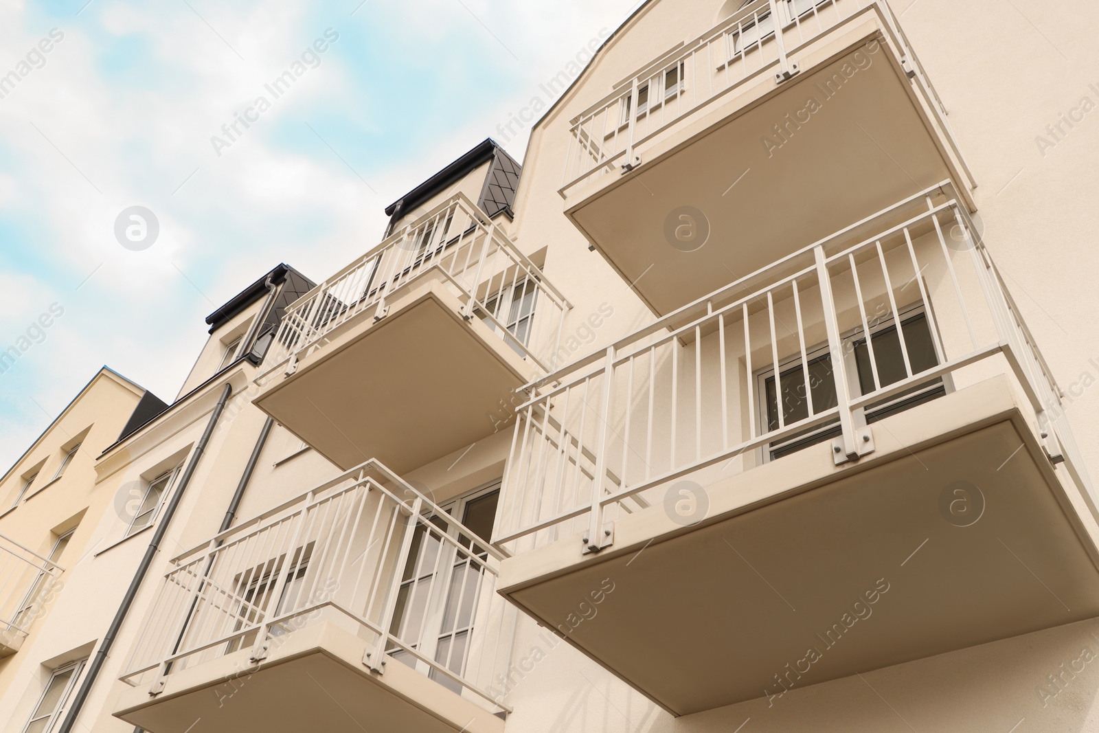 Photo of Exterior of beautiful building with empty balconies, low angle view