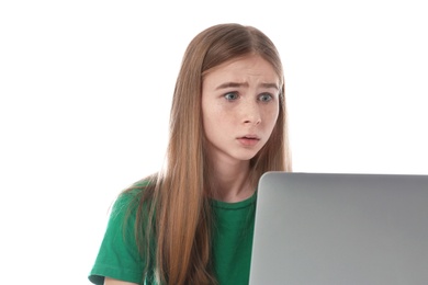 Photo of Shocked teenage girl with laptop on white background. Danger of internet
