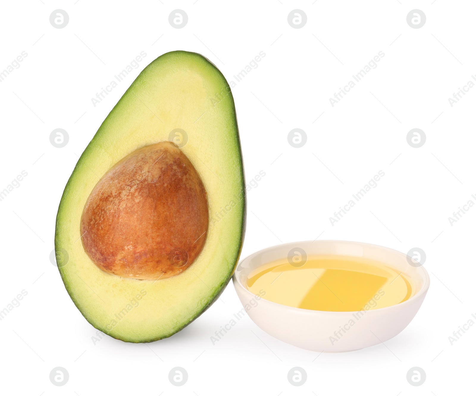 Photo of Cooking oil and half of fresh avocado isolated on white