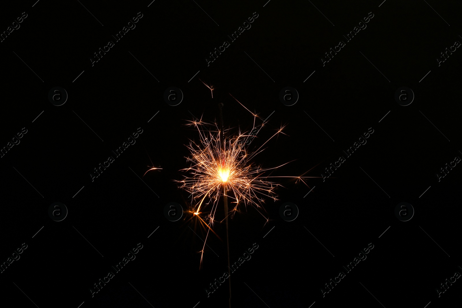 Photo of Burning sparkler stick on black background, space for text