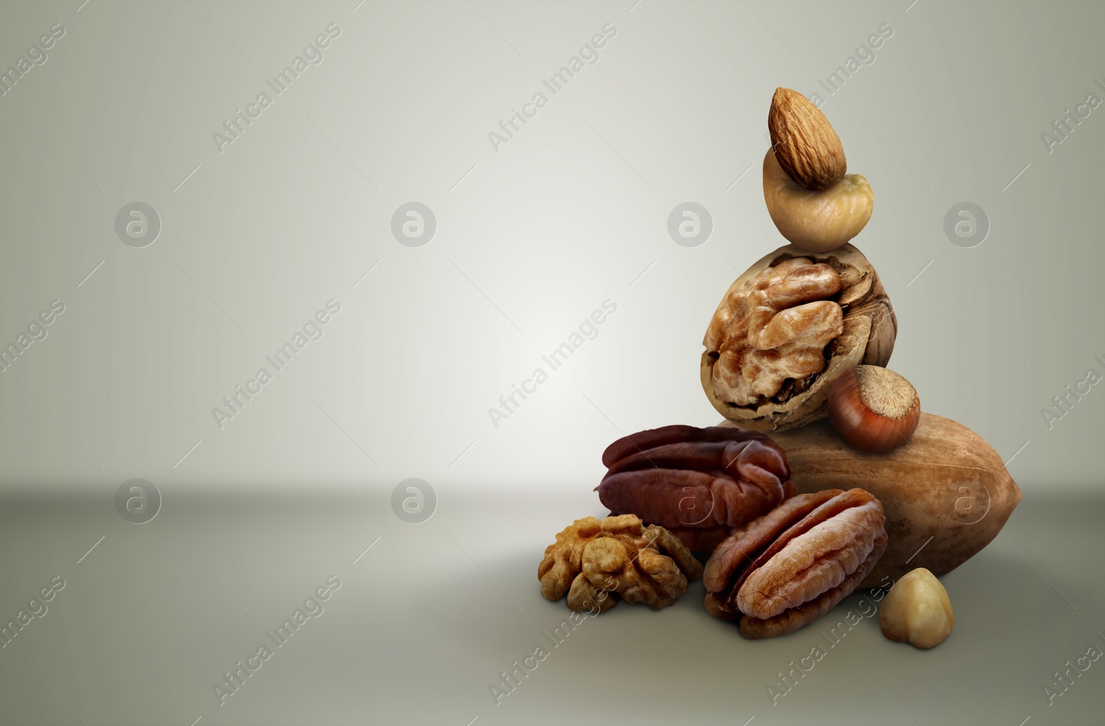 Image of Different nuts on light grey gradient background, space for text