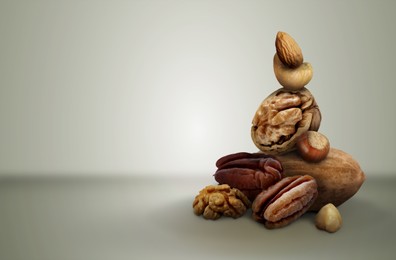 Image of Different nuts on light grey gradient background, space for text