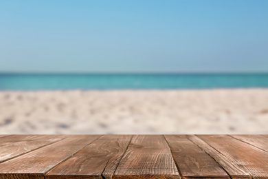 Image of Wooden surface on sandy beach near ocean