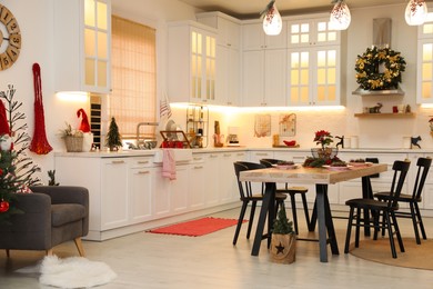 Cozy dining room interior with beautiful Christmas wreath and festive decor