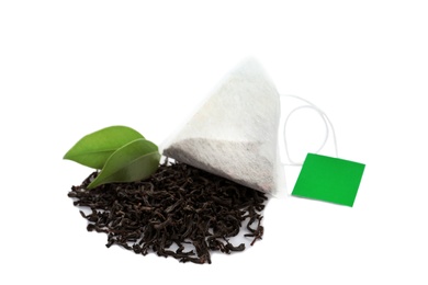 Tea bag and dry leaves on white background