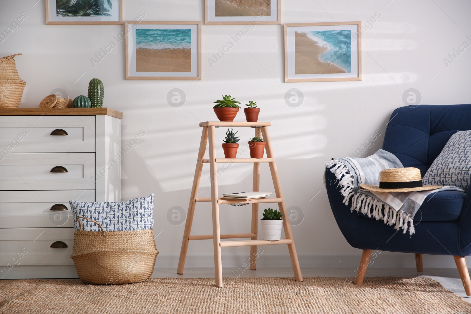 Photo of Stylish living room interior with wooden ladder and comfortable armchair