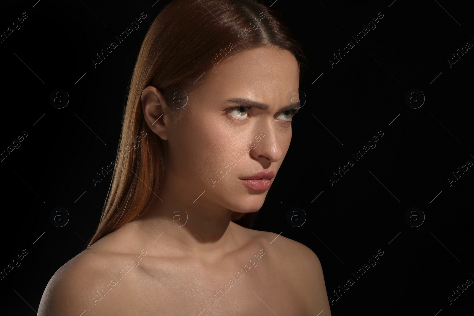 Photo of Evil eye. Young woman with scary eyes on black background