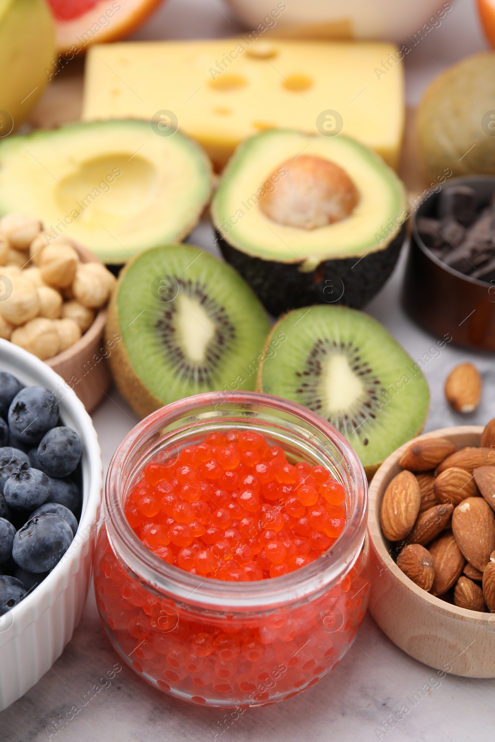 Photo of Many different products on white table, closeup. Natural sources of serotonin