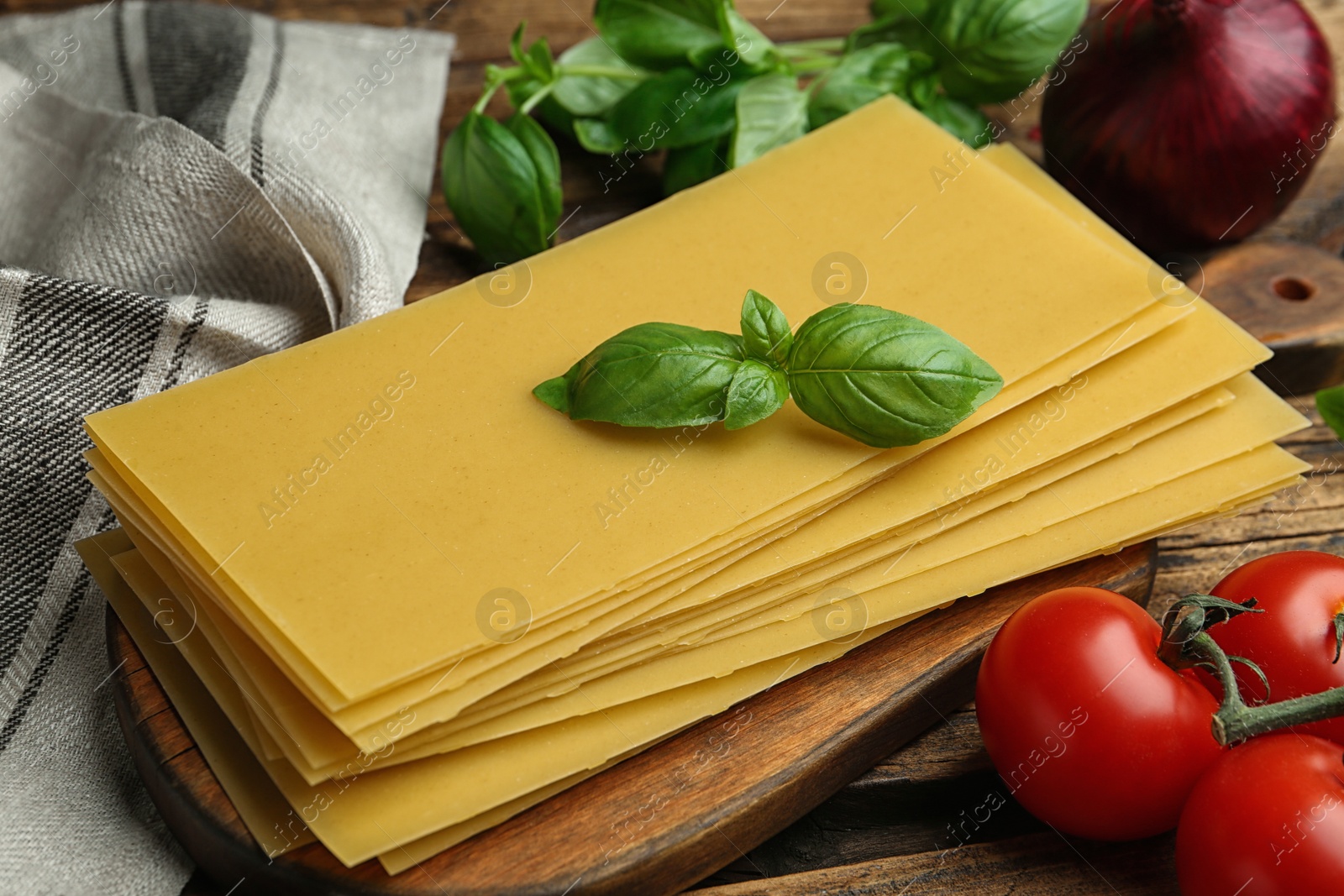 Photo of Composition with uncooked lasagna sheets on wooden table